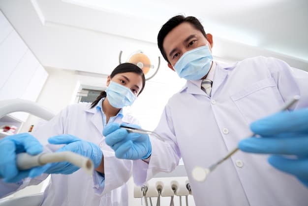 Two dental clinicians preparing beside a patient chair
